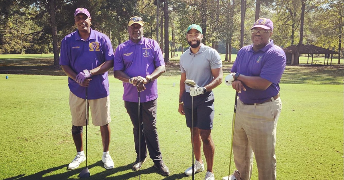 a group of baseball players standing on top of a grass covered field